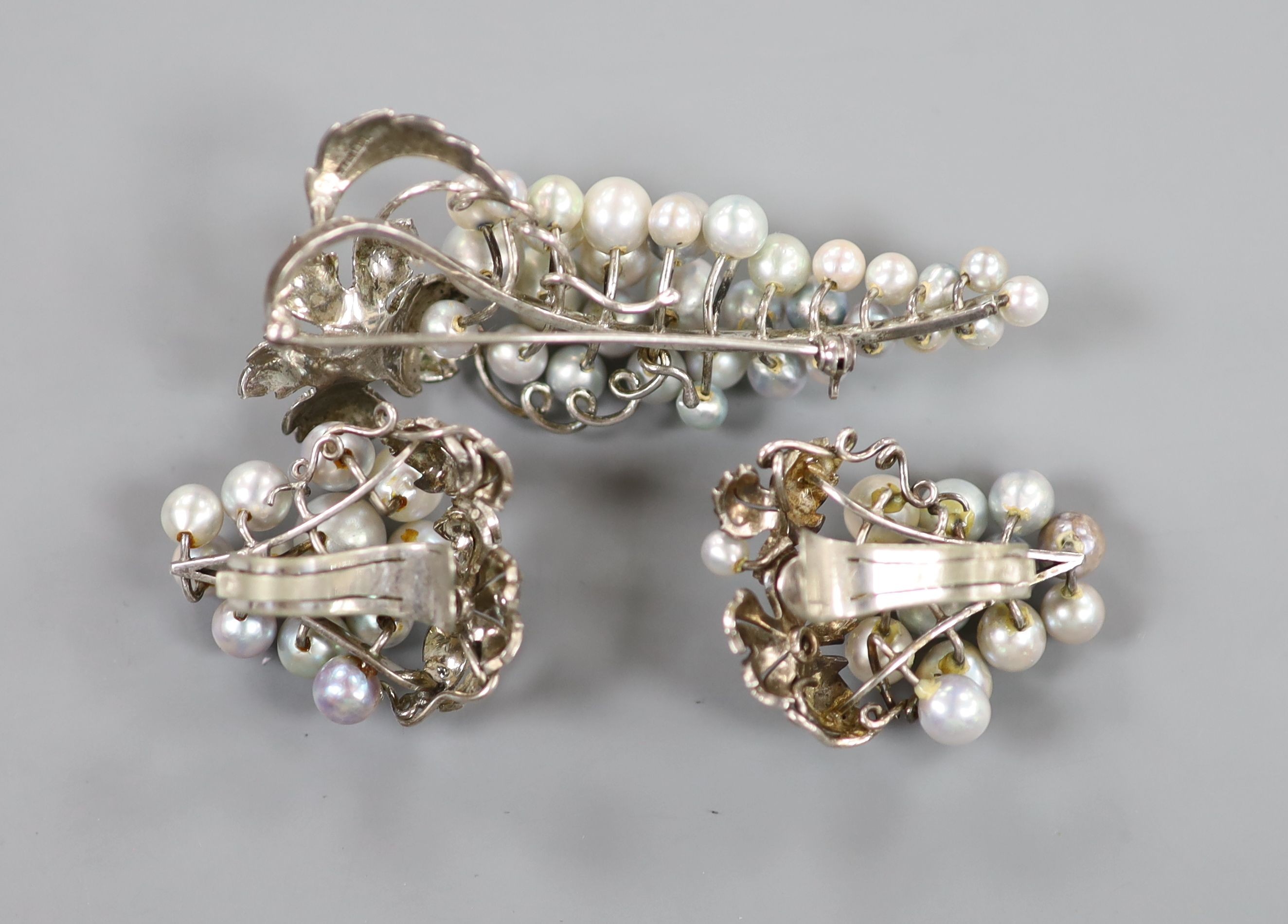 A modern suite of sterling and cultured pearl cluster jewellery, of vineous design, comprising a brooch, 65mm and pair of ear clips, 33mm